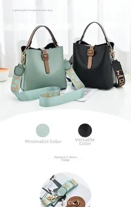 Detail of mint green and black bucket bags with wide jacquard and leather straps