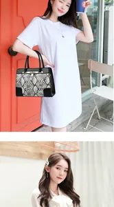 Close-up of snakeskin pattern leather handbag with elegant gold metal lock and hardware
