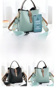 Close-up of bucket bag with wide colorful printed shoulder strap in mint and black