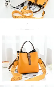 Macro shot of yellow bucket bag showing smooth PU leather and patterned shoulder strap