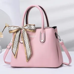 Close-up of pink stone pattern handbag with printed silk scarf and silver metal hardware