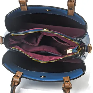 Blue faux leather bucket bag with brown handles and multi-layer inner compartments