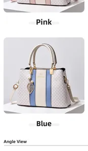 Detail of luxury monogram handbag featuring contrast stripes and gold leaf pendant