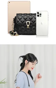 Detailed comparison of the black quilted crossbody bag size with tablet and phone