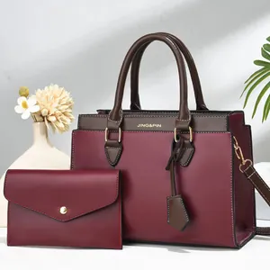 Close-up of a two-piece women handbag set including a tote bag and a matching wallet