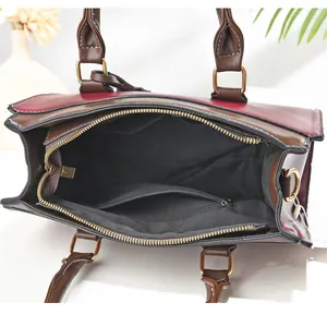 Detailed interior of contrast handbag featuring spacious main compartment and gold zippers