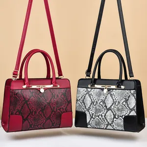 Elegant snakeskin pattern handbags in burgundy and bicolor with gold hardware details