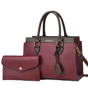 Deep burgundy 2-piece handbag set with brown handles and adjustable shoulder strap