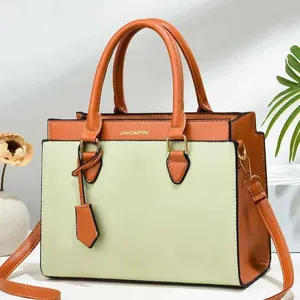 Contrast color women's handbag in orange and light green with crossbody strap and JING&PIN logo