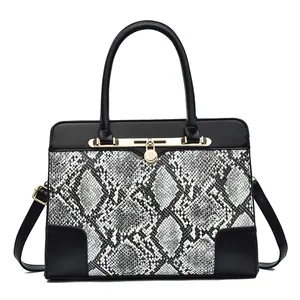 Women's faux leather handbag with black and white snakeskin pattern and gold hardware