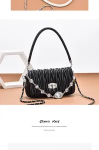 Detail of Matelassé pleated leather handbag with crystal chain and metal clasp