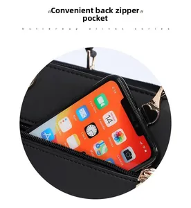 Close-up of practical anti-theft back zipper pocket on black leather shoulder bag
