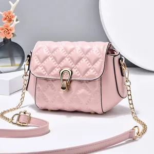 Pink quilted shoulder bag with gold horseshoe buckle on elegant display stand