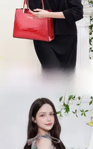 Detail view of red glossy faux crocodile leather texture and gold logo on luxury handbag