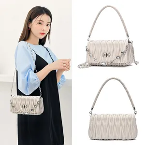 Chic beige quilted shoulder bag with braided handle and sparkly rhinestone chain