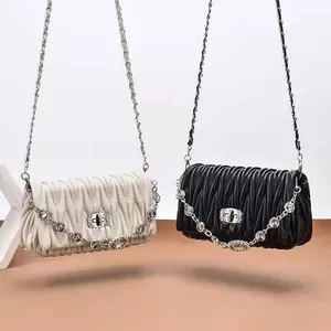 Chic pleated mini shoulder bags in black and white with elegant chain and pearl details