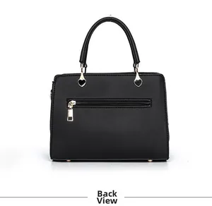 Detail back view of a black leather handbag featuring heart-shaped gold hardware and zipper