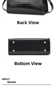 Detail view of glossy faux crocodile leather handbag with golden protective bottom studs