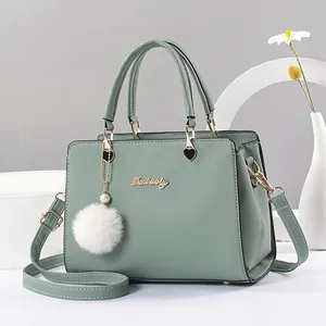 Elegant mint green textured PU leather handbag with gold metal logo and plush charm