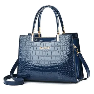 Deep blue patent leather handbag with crocodile pattern and metallic handle hardware