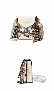 Detail view of mini teddy bear flap bag with silk scarf handle and golden hardware