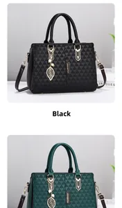 Detail of embossed triangle texture on black handbag with gold leaf pearl charm