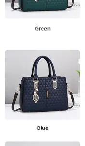 Detail of fashion wing-style handbags in green and blue with gold charms and leaf accents