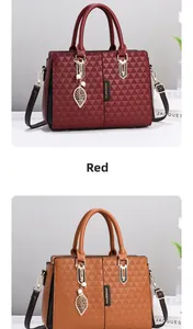 Detailed view of red and brown tote bags with triangular texture and leaf pendant