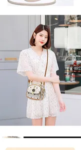 Asian model wearing a white floral dress with a cartoon cat charm crossbody bag