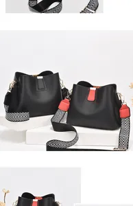 Detail of premium lychee texture bucket bag with a stylish geometric wide strap