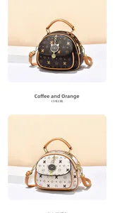 Detail view of retro monogram handbags with cat-shaped gold charms in coffee and orange colors