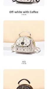 Detail of the cat-shaped enamel clasp and patterned PU leather on the crossbody bag