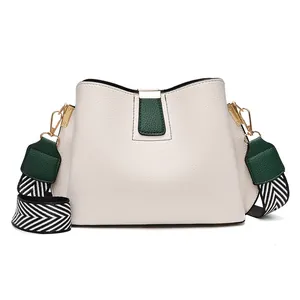 Off-white and green leather bucket bag with wide zigzag strap and gold hardware