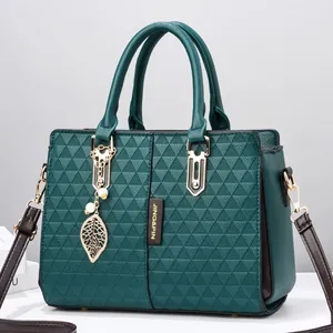 Dark green winged handbag with 3D triangle texture and elegant gold leaf pendant decor