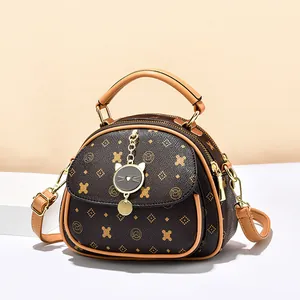Retro monogram shell handbag with cat charm and three zipper layers in dark brown leather