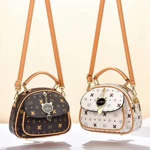 Cartoon print satchel with cat charm and adjustable strap in dark coffee and beige