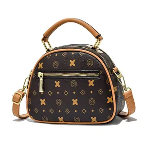 Brown monogram shell tote bag with light tan trim and adjustable shoulder strap