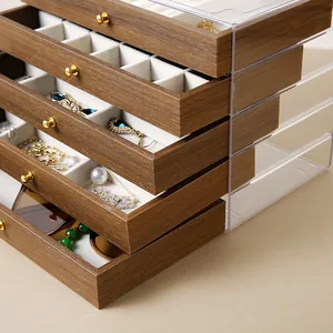 Macro detail of walnut grain jewelry box with acrylic drawers and golden handles