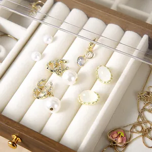 Detail view of premium walnut jewelry box with pearl earrings and tulip heart necklace