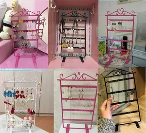 Detail of multi-tier 48-hole iron earring display stand with elegant heart top scroll