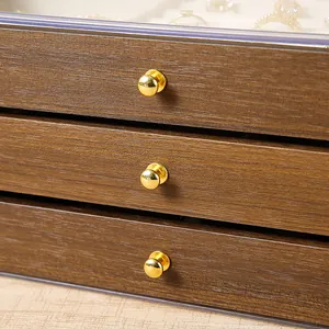 Three-layer walnut jewelry box featuring elegant gold knobs and a clear top display lid