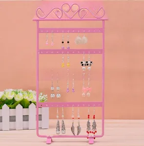 Detailed view of pink iron earring holder with 48 holes and decorative heart top