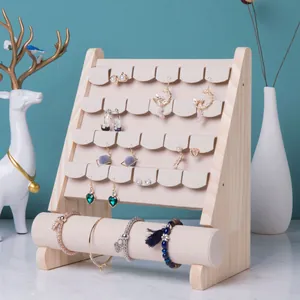 Detail of wooden jewelry display stand with velvet tiers and horizontal bracelet bar