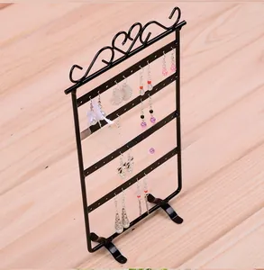Detail of 48-hole black iron earring stand showing various jewelry styles and stable legs