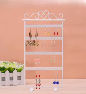 White metal earring display rack with four layers and decorative hollow heart design