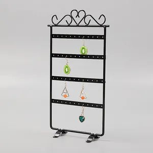 Black metal jewelry organizer stand with 48 holes and elegant heart-shaped scrolled top