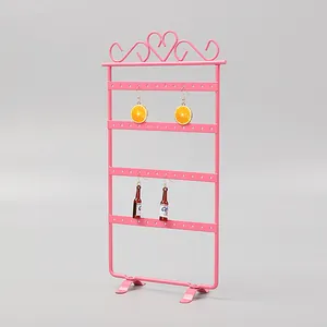 Pink metal 48-hole earring display stand with heart scrollwork and stable desk base