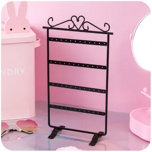 Black iron 48-hole earring display rack with heart scroll patterns and four tiered layers