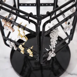 Rotating black metal earring stand with multiple levels for jewelry storage and display