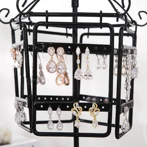 Rotating black iron jewelry stand with multiple holes for organizing diverse earrings